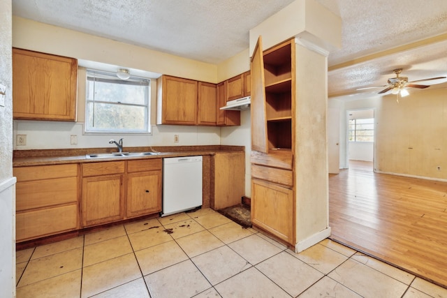 kitchen with sink, a textured ceiling, ceiling fan, light wood-type flooring, and white dishwasher