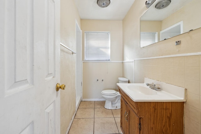 bathroom featuring tile patterned flooring, vanity, and toilet