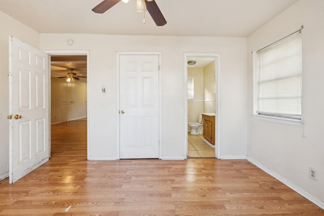 unfurnished bedroom featuring ceiling fan, light hardwood / wood-style flooring, and connected bathroom