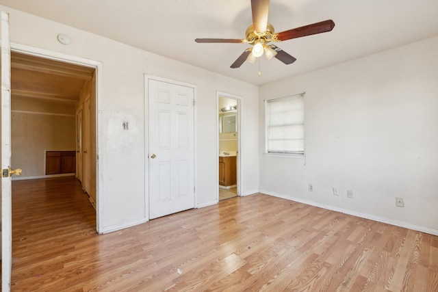 unfurnished bedroom with ceiling fan, light wood-type flooring, and ensuite bathroom