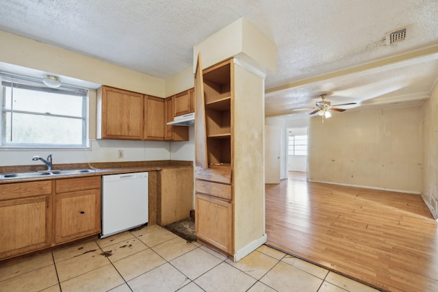 kitchen featuring sink, a textured ceiling, ceiling fan, light tile patterned floors, and white dishwasher