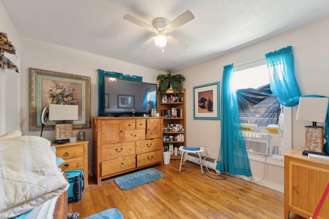 interior space with ceiling fan, light wood-type flooring, and a textured ceiling