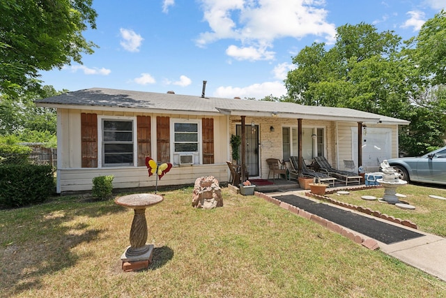 ranch-style house featuring a porch, a garage, and a front yard