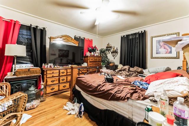 bedroom with wood-type flooring and ceiling fan