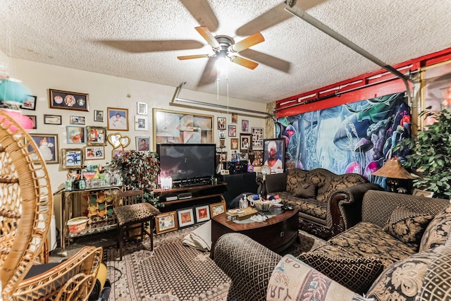 living room featuring ceiling fan and a textured ceiling