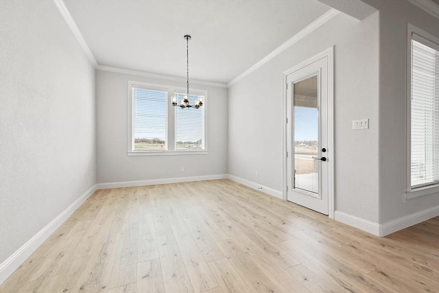 unfurnished dining area with light hardwood / wood-style floors, an inviting chandelier, and ornamental molding