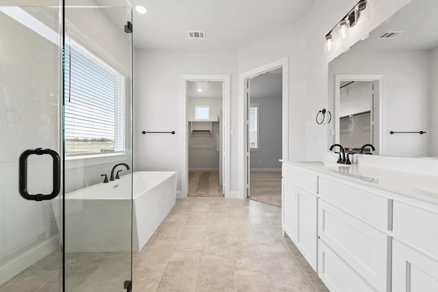 bathroom featuring vanity and separate shower and tub