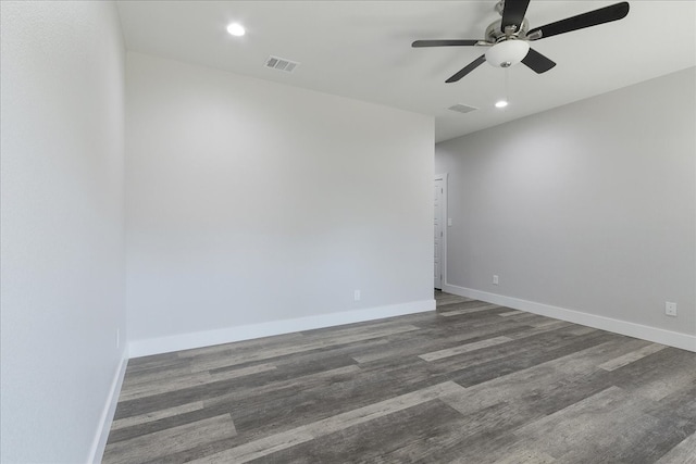 empty room featuring ceiling fan and dark hardwood / wood-style flooring