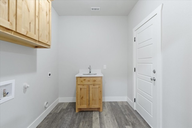 laundry area with dark hardwood / wood-style flooring, hookup for an electric dryer, hookup for a gas dryer, cabinets, and hookup for a washing machine