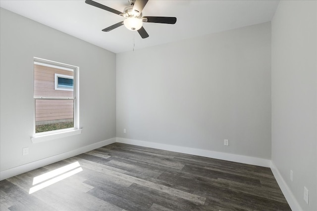 empty room with dark hardwood / wood-style floors and ceiling fan