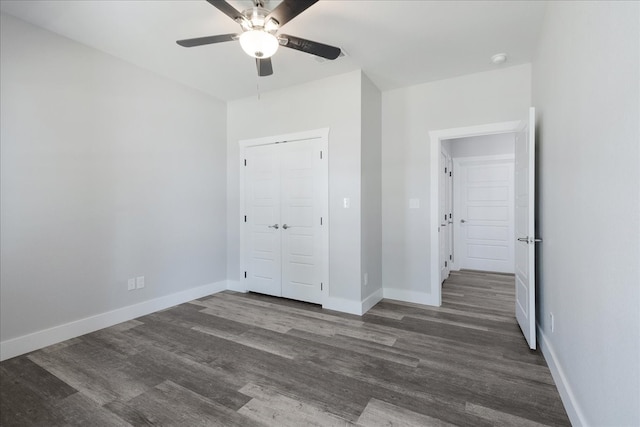 unfurnished bedroom featuring ceiling fan, dark hardwood / wood-style flooring, and a closet