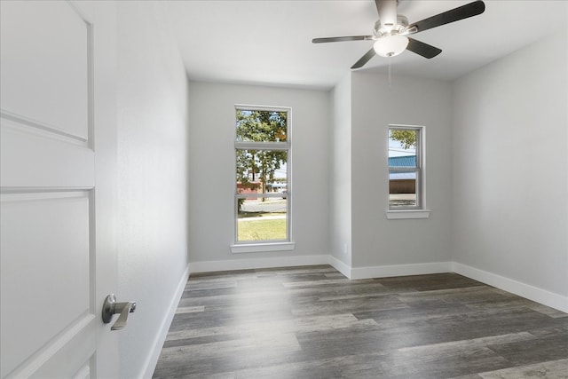 unfurnished room with hardwood / wood-style floors, a wealth of natural light, and ceiling fan