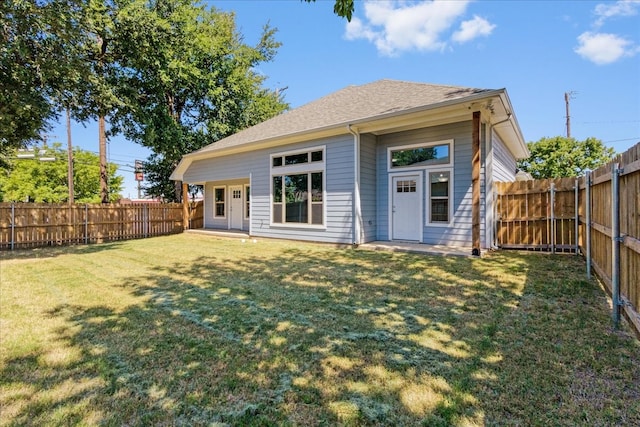 rear view of house with a lawn