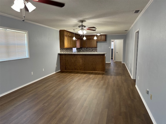 kitchen featuring tasteful backsplash, kitchen peninsula, dark wood-type flooring, ceiling fan, and hanging light fixtures