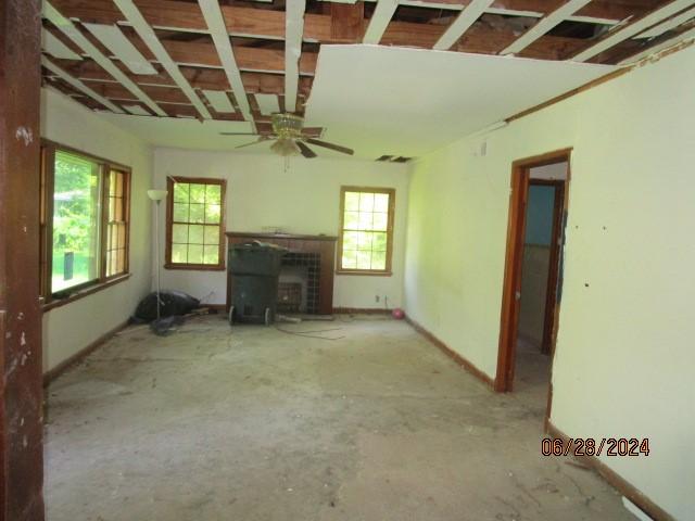 unfurnished living room featuring ceiling fan