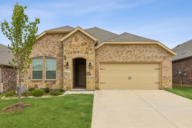 view of front of home with a garage and a front yard