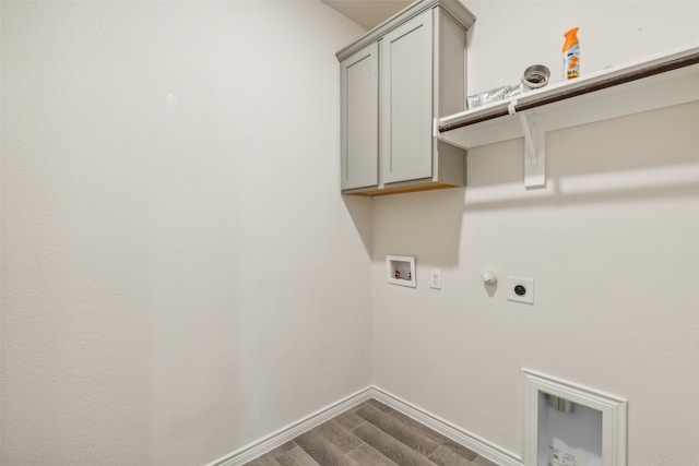 clothes washing area featuring cabinets, hookup for a washing machine, wood-type flooring, hookup for an electric dryer, and hookup for a gas dryer