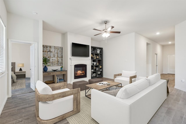 living room with ceiling fan and light hardwood / wood-style flooring