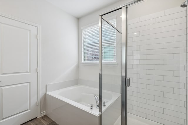 bathroom with separate shower and tub