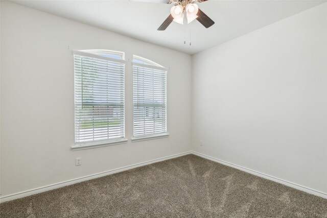 empty room with ceiling fan and carpet