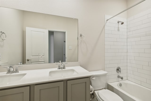 full bathroom with tiled shower / bath, toilet, and double vanity