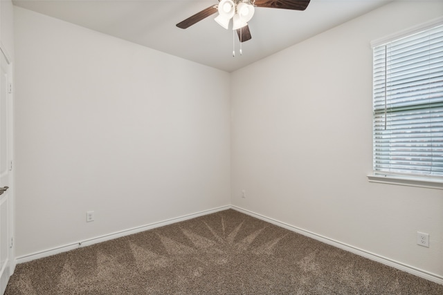 carpeted empty room with a wealth of natural light and ceiling fan