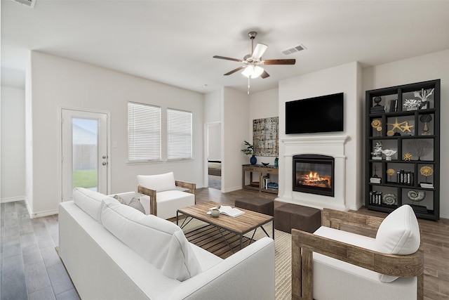 living room featuring ceiling fan and wood-type flooring