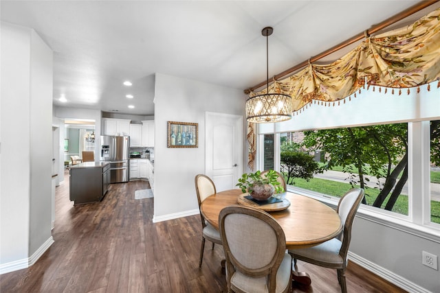 dining room featuring plenty of natural light, dark hardwood / wood-style floors, and a chandelier