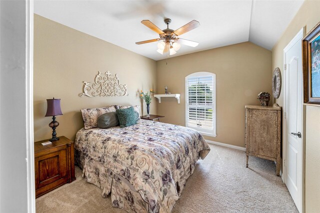 bedroom with vaulted ceiling, light carpet, and ceiling fan