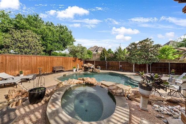 view of swimming pool featuring an in ground hot tub and a patio area