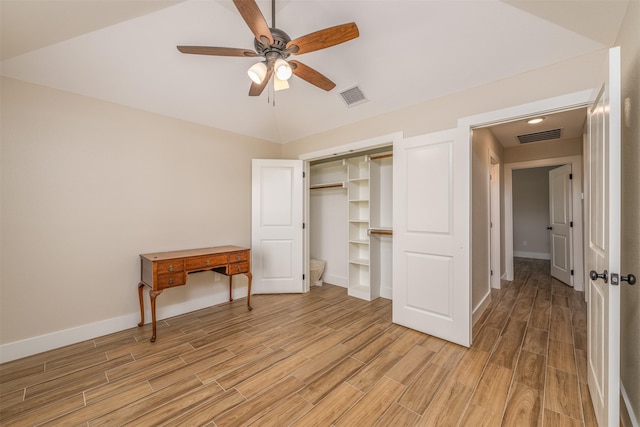 bedroom featuring lofted ceiling, ceiling fan, and a closet