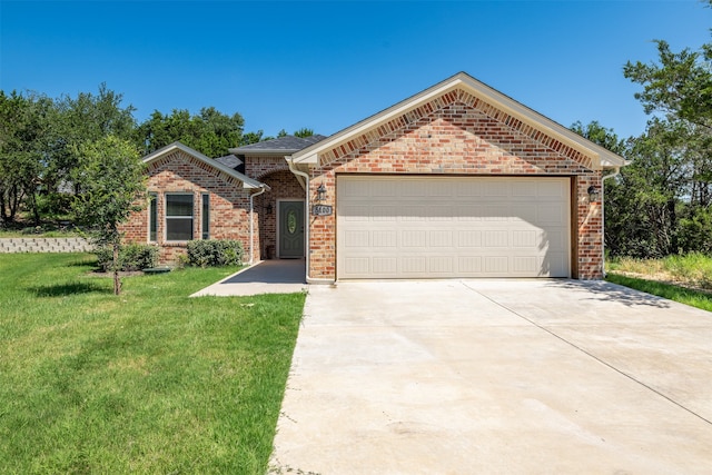 single story home featuring a garage and a front lawn