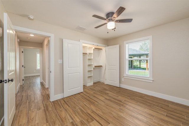 unfurnished bedroom with ceiling fan, a closet, and light hardwood / wood-style flooring