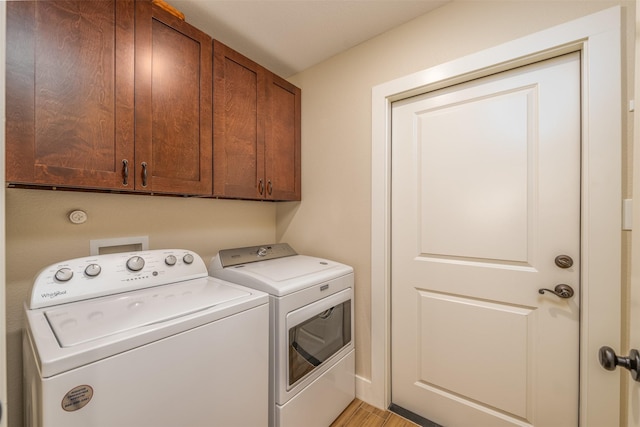 laundry area with cabinets and washing machine and dryer