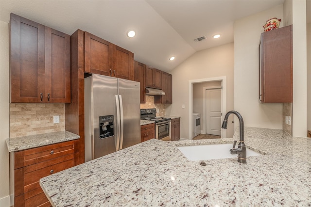 kitchen with sink, light stone countertops, kitchen peninsula, and appliances with stainless steel finishes