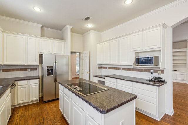 kitchen featuring a center island, white cabinetry, dark wood-type flooring, and appliances with stainless steel finishes