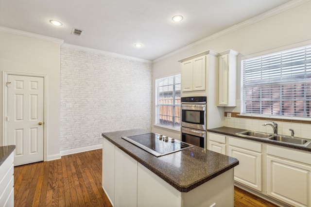 kitchen featuring white cabinetry, sink, dark hardwood / wood-style flooring, double oven, and black electric stovetop