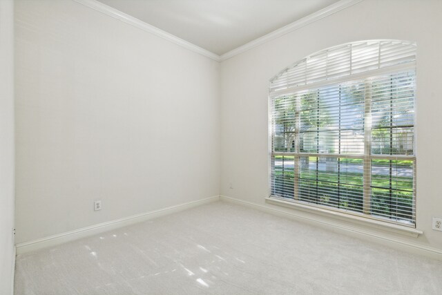 unfurnished bedroom with ceiling fan, ornamental molding, light carpet, and vaulted ceiling