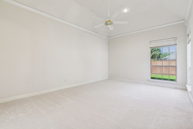 unfurnished room featuring ceiling fan, light colored carpet, and crown molding