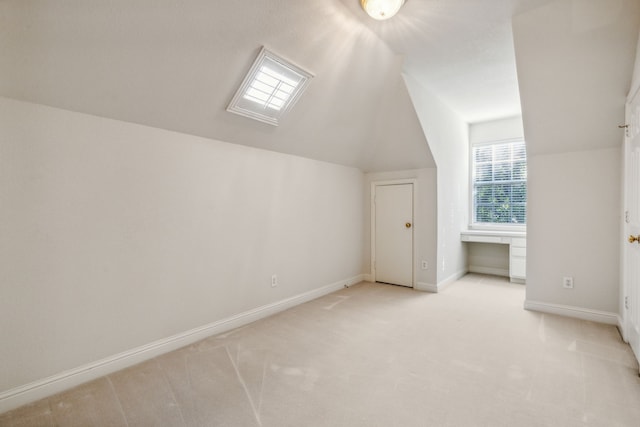 bonus room featuring light carpet and vaulted ceiling