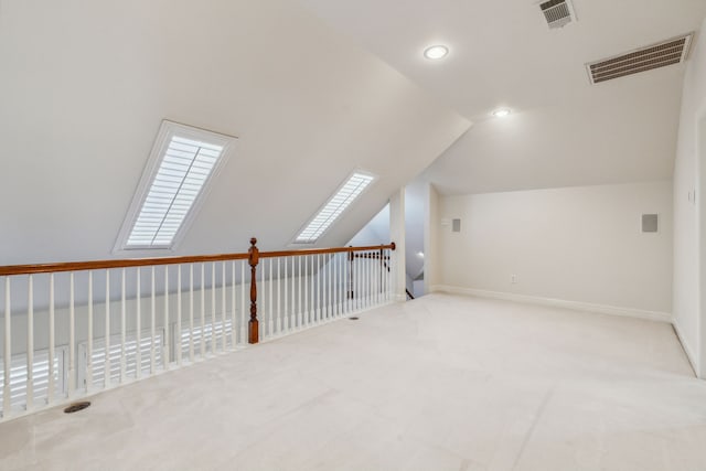 additional living space with light carpet and lofted ceiling