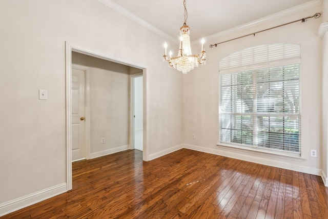 empty room with a notable chandelier, crown molding, and dark wood-type flooring