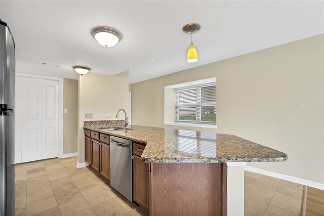 kitchen with pendant lighting, sink, dishwasher, light stone countertops, and light tile patterned floors