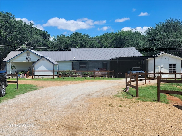 5280 Atwell Ln, Denton, TX 76208 - ranch-style house with dirt driveway, metal roof, fence, and a carport