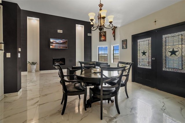 dining space with french doors and an inviting chandelier