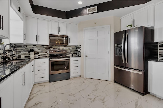 kitchen with white cabinets, appliances with stainless steel finishes, and sink