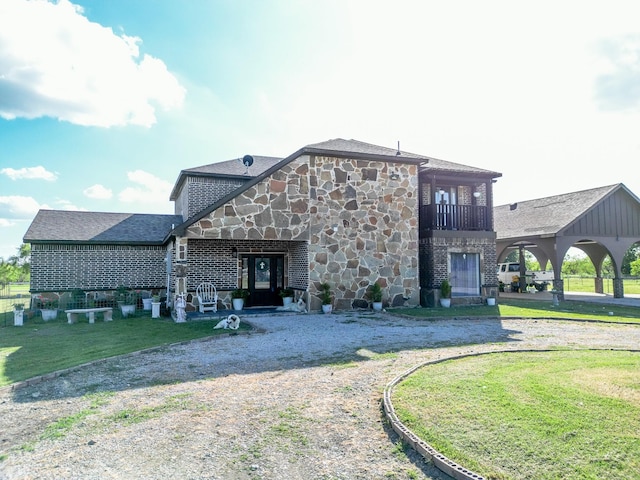 rear view of property featuring a yard