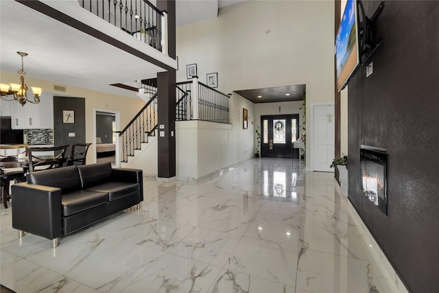 interior space with a high ceiling and a chandelier