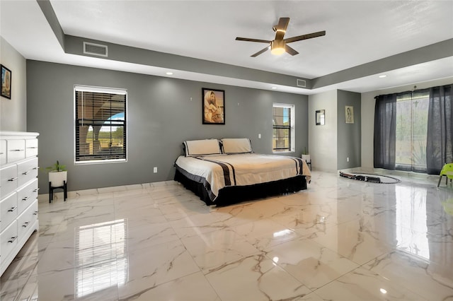 unfurnished bedroom featuring multiple windows and ceiling fan