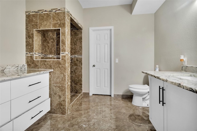 bathroom with a shower, vanity, and toilet